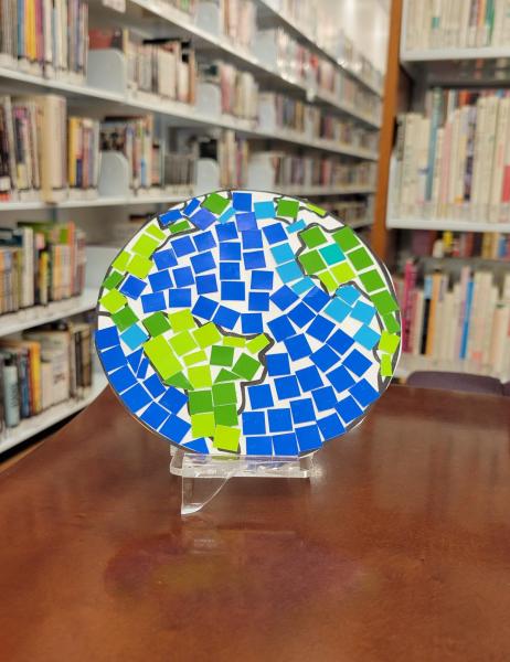 Photo of a mosaic image of the earth sitting on a table in the library.