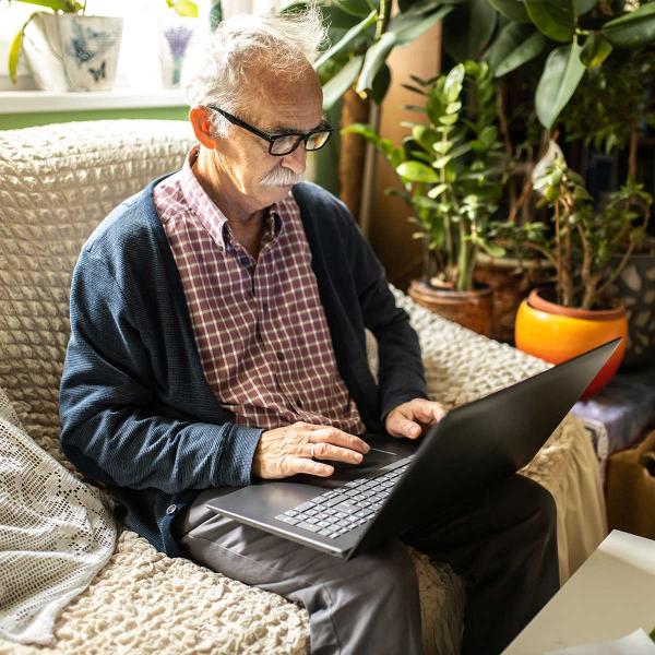 Elderly man using laptop 