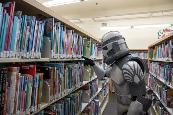 A stormtrooper searching for books in the library.