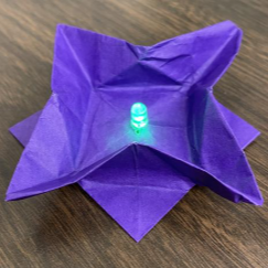 purple origami star with a LED in the middle