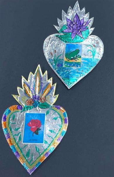  two foil hearts colored with markers and with pictures of a rose and frog