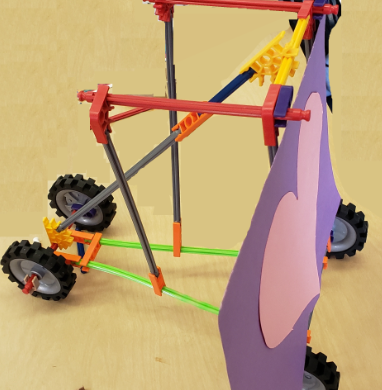 colorful stick contraption with wheels