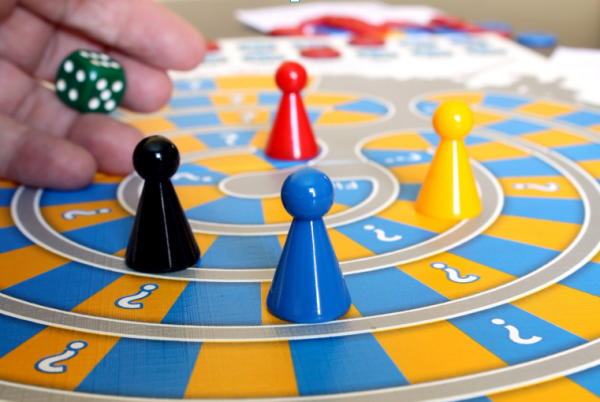 Board game with 4 pieces (blue, yellow, black and red) 