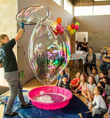 Man making giant bubbles in front of audience