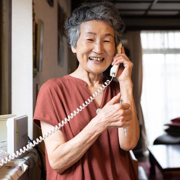 Woman smiling while speaking on phone.