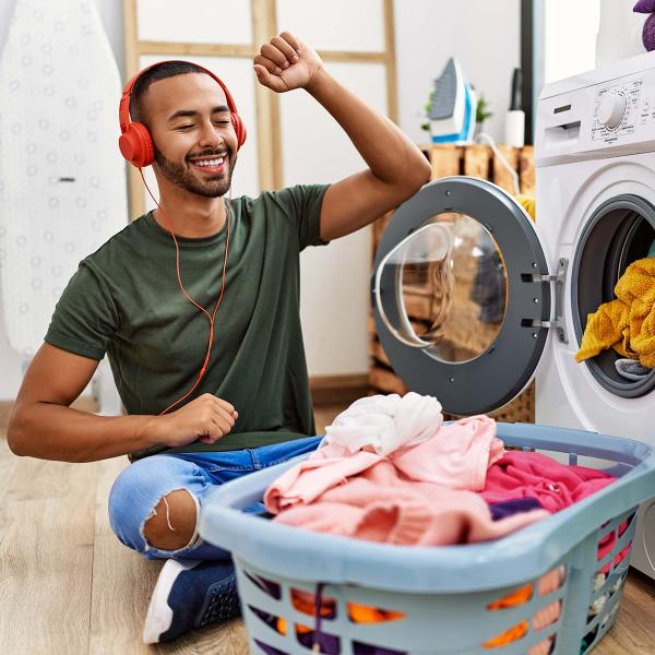 Man doing laundry while listening to music