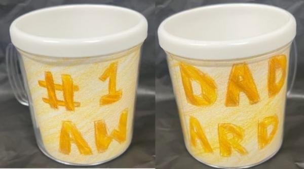 Two plastic mugs decorated with writing that reads #1 DAD AWARD.