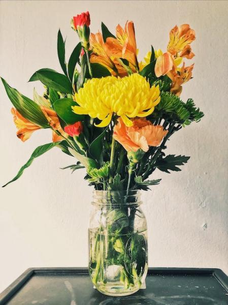 Vase with yellow and orange flowers 