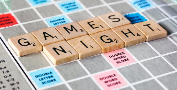 Scrabble game pieces spelling out words GAMES NIGHT 