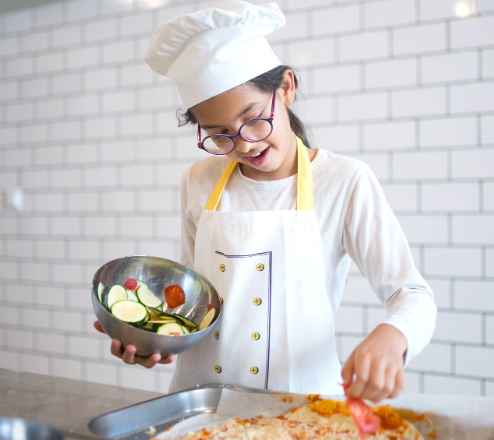 female child cooking