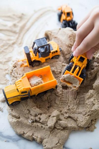 Playing with trucks in the sand