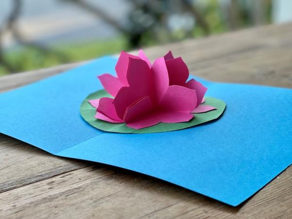 POP UP card of a pink lotus flower on blue paper 