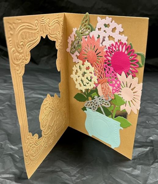 A greeting card with a picture of flowers in a pot.