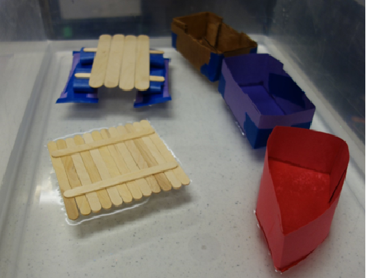 paper boats with popsicle sticks in water