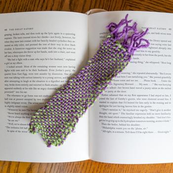Handwoven bookmark placed on top of book