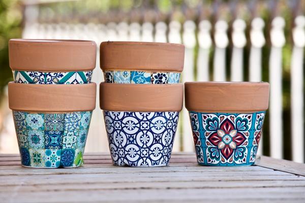 Several flower pots decorated with geometric designs.