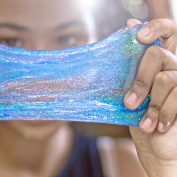 Girl making blue glitter slime