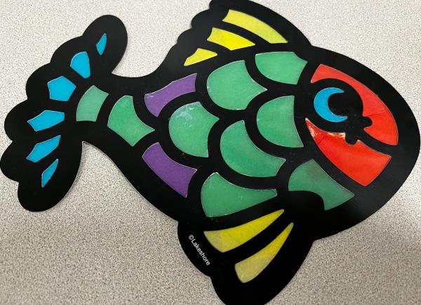 A colorful fish made from paper and cellophane.