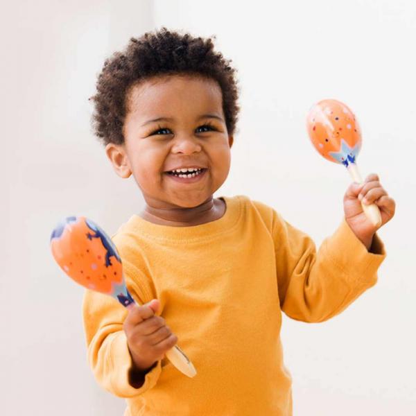 Baby holding and shaking maracas