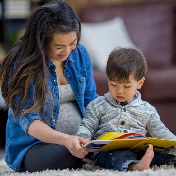Mother and baby looking at picture book together