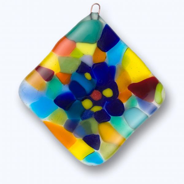 A square glass ornament with multicolored shapes