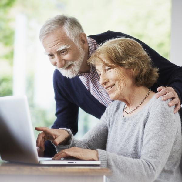 Older couple using laptop together.