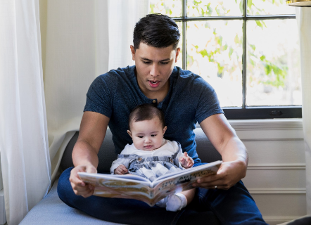 Dad reading with a baby