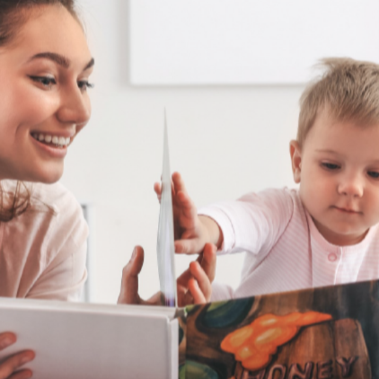 woman and small child looking at boardbook