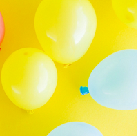 yellow and blue balloons against yellow background