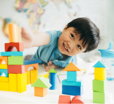 Child playing with colorful building blocks 