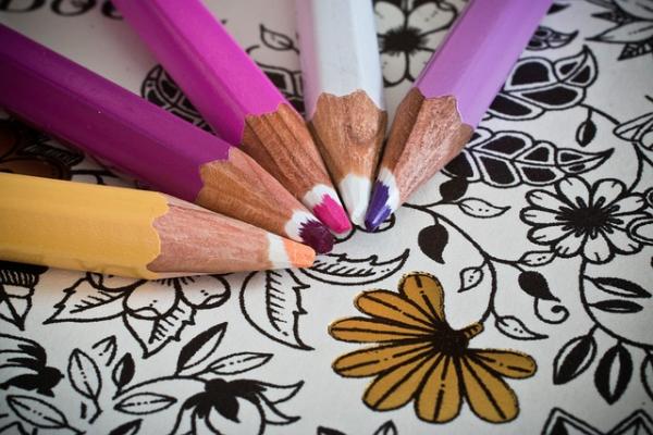 Five color pencils on a coloring page