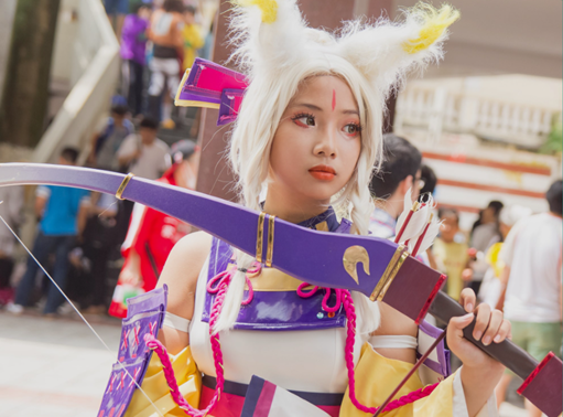 asian girl in cosplay outfit with bow and arrow