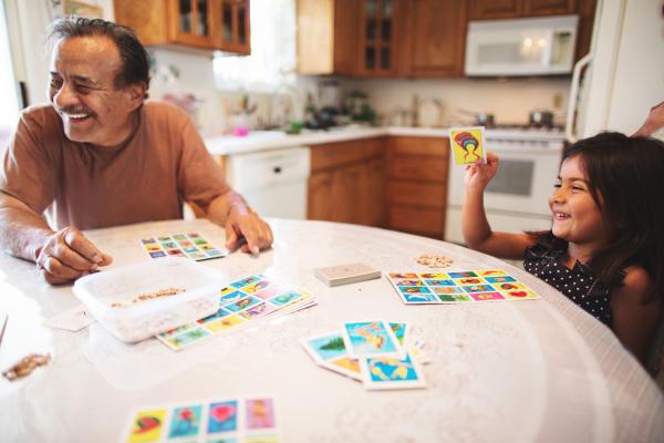 Grandpa and grandaughter playing lotería