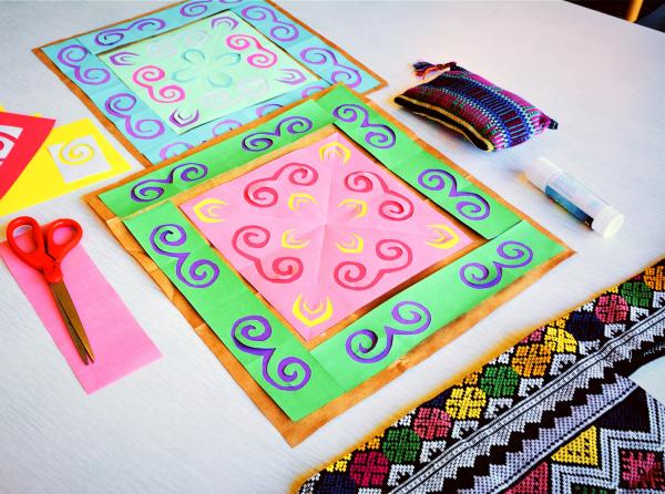 hmong paj ntaub motifs on colorful paper