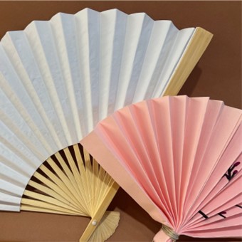 two paper fans, pink and white