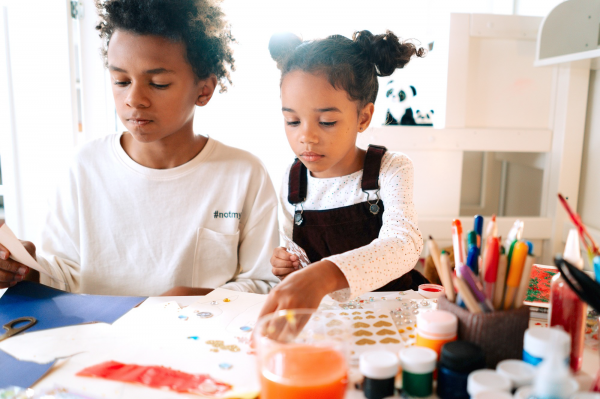 Two children using art materials 