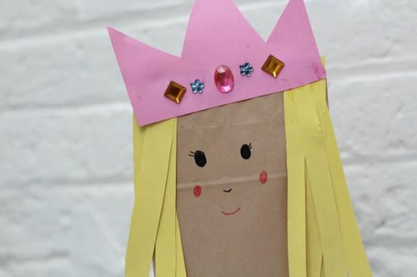 Brown paper bag art activity used to create a princess with a pink crown 