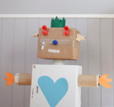 cardboard robot with a green paper crown