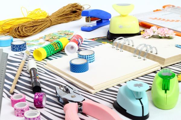 Paper crafting supplies - glue, hole-punch, washi tape, string, stapler, paper punches