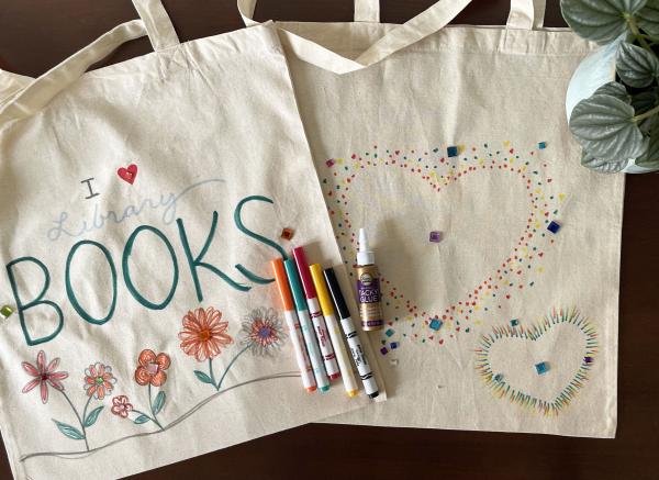 Two tote bags. The first says "books" and has flowers, the second has hearts on it.