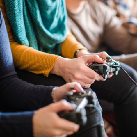 teens handling video game controllers